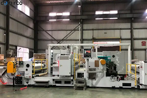 نمای نزدیک از نازل دستگاه چسب هات ملت پلی اورتان در حال اعمال چسب روی لبه نوار ام‌دی‌اف