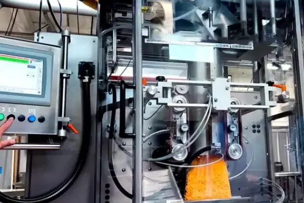 دستگاه پرکن توزین دار اتوماتیک پیشرفته در حال پر کردن بسته‌های حبوبات در یک کارخانه مدرن