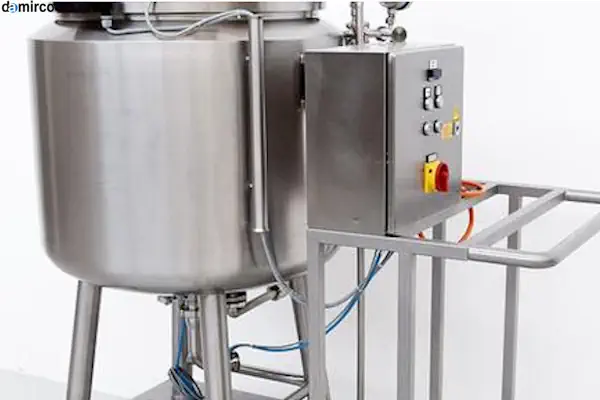 یک میکسر مایعات آزمایشگاهی از نوع مکانیکی در حال هم زدن مایعی آبی رنگ در یک بشر شیشه‌ای