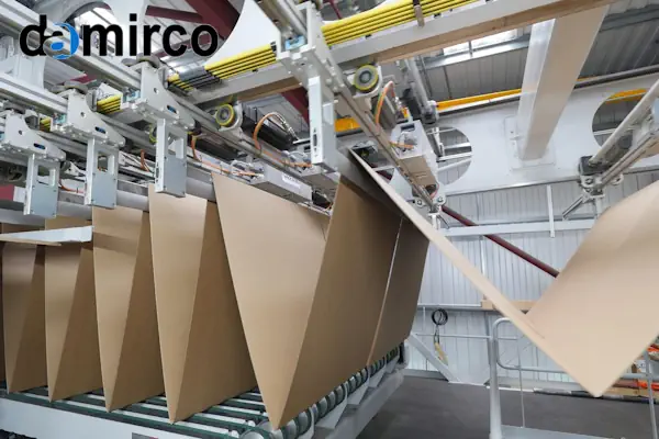 تصویر یک دستگاه کارتن فورمینگ اتوماتیک در حال شکل‌دهی به کارتن در یک خط بسته‌بندی صنعتی